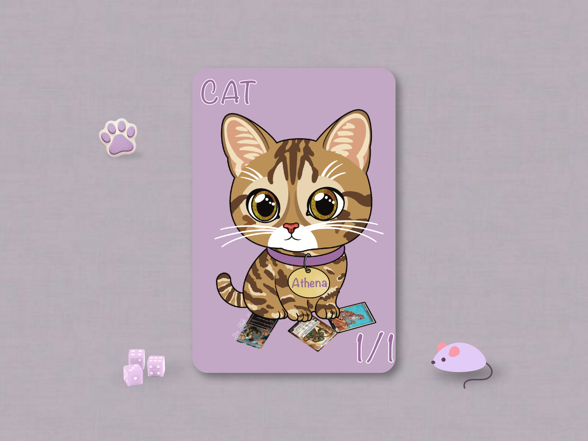 Hand-drawn 1/1 Cat custom MTG token card featuring a cute brown tabby cat named Athena sitting on a stack of Magic cards against a soft lilac background, illustrated by artist Lori Faith of Purple Fox Shop.