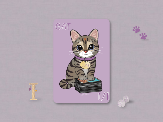 Hand-drawn 1/1 Cat custom MTG token card featuring a cute brown tabby kitten named Athena sitting on a stack of Magic cards against a soft lilac background, illustrated by artist Lori Faith of Purple Fox Shop.