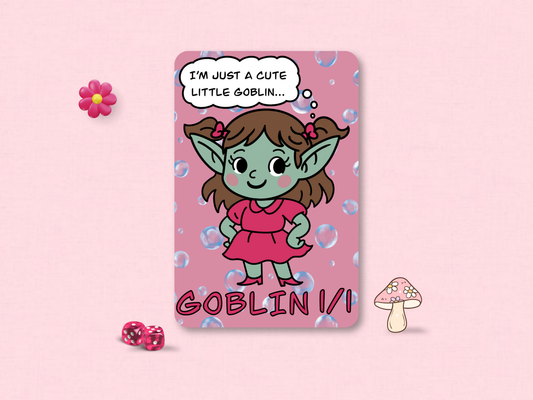 Front face of a custom MTG 1/1 Goblin game token featuring a green chibi goblin girl in a pink dress hand-drawn by Lori Faith on a bubble background.